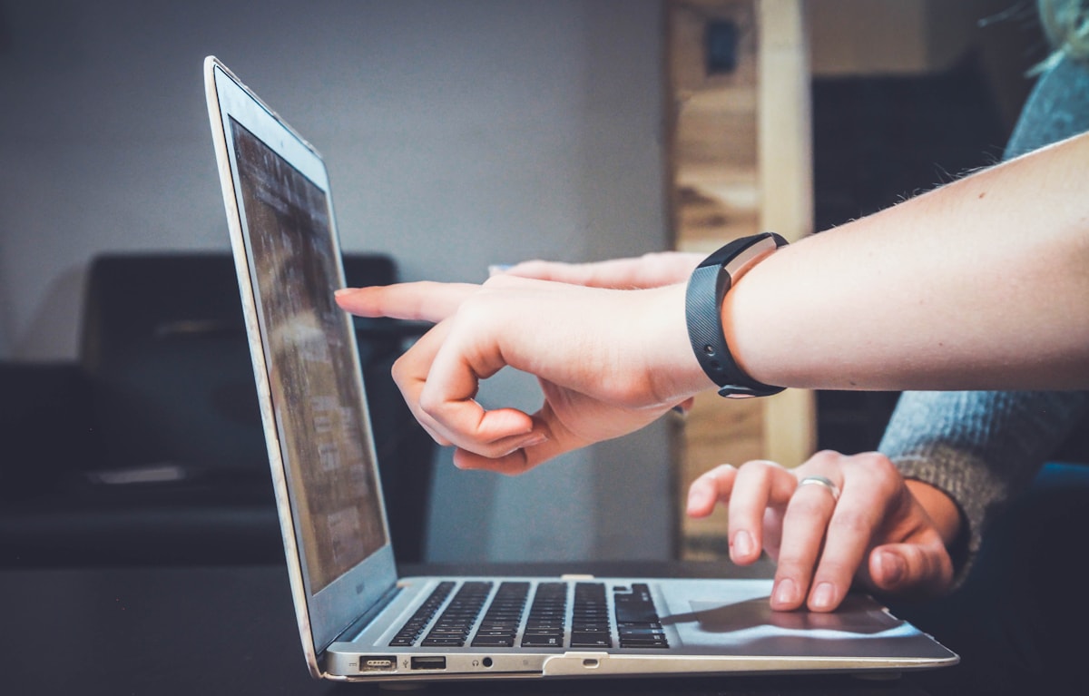 Two people reviewing work on a laptop