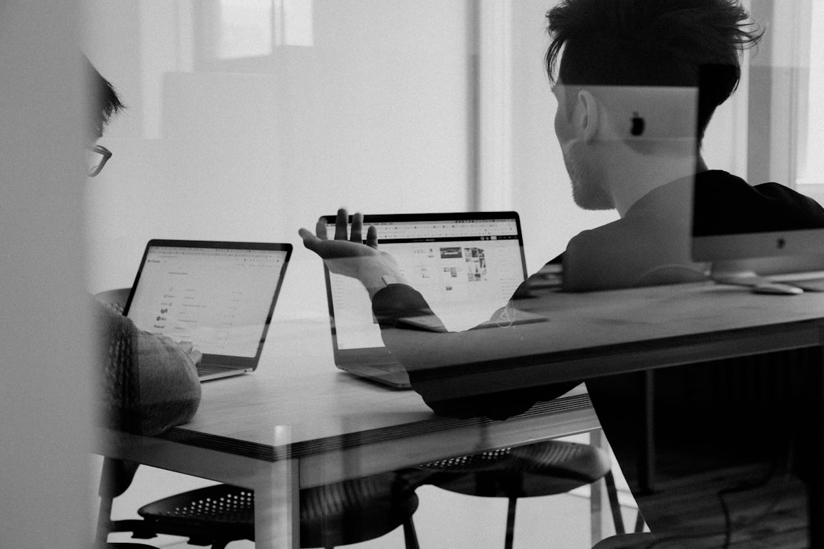 Team members discussing a digital project through a glass wall